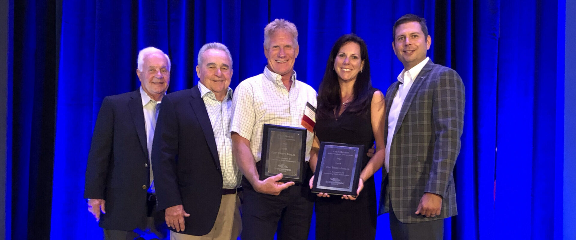 Mark & Cheryl Passeri Receiving Top 30 Dealer Award from Chaparral Founder Buck Pegg & Chaparral Executives